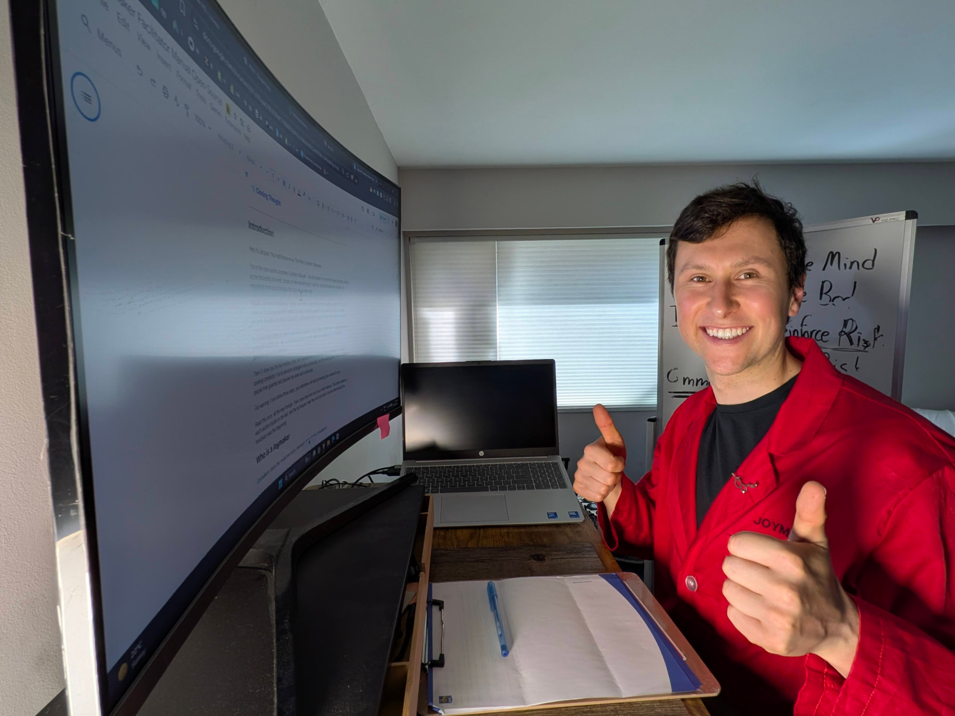 Jacques giving two thumbs up while preparing a virtual session at his desk